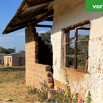 An abandoned, damaged building with partially collapsed walls and broken windows. Labeled 'before'.